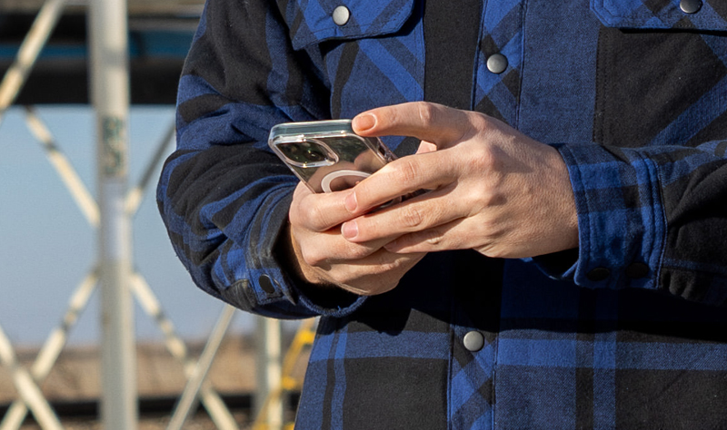 Close up of man using smart phone to message