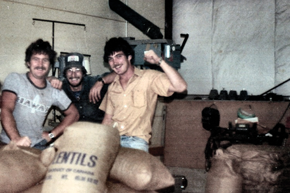 Old Picture of Gre, Tom and Jogn Simpson posing with bags of lentils