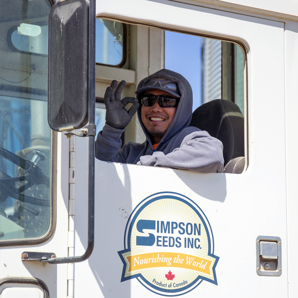 Simpson Seeds Employee in Semi Truck smiling