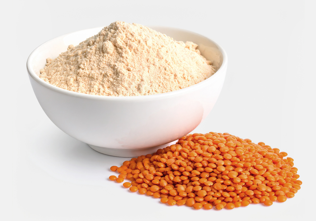 Bowl of lentil flour and pile of green lentils